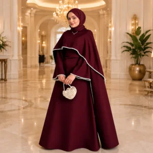 Woman wearing designer maroon modest gown with cape